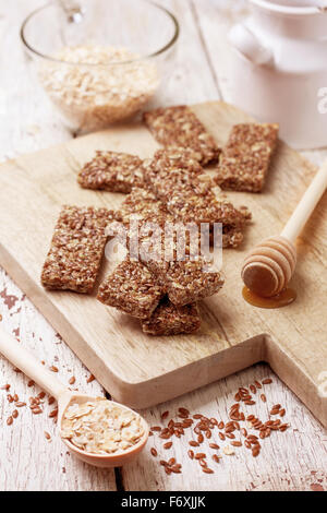 cereal bars, oatmeal, flax seeds on a wooden background Stock Photo