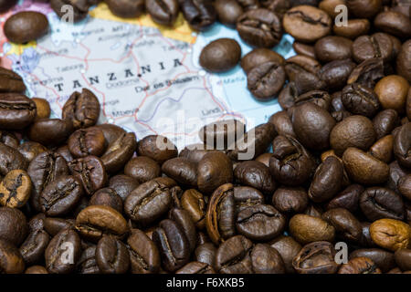 Geographical map of Tanzania covered by a background of roasted coffee beans. This nation is one of the main producers and expor Stock Photo