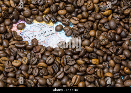 Geographical map of Tanzania covered by a background of roasted coffee beans. This nation is one of the main producers and expor Stock Photo