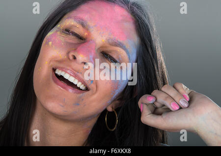 Beautiful young brunette girl with colorful decorated face Stock Photo