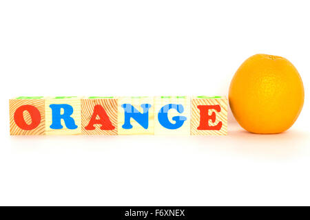 Wood cube with inscription ORANGE Stock Photo