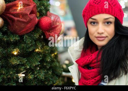 Pretty girl by the Christmas tree Stock Photo