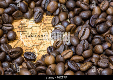 Vintage map of Tanzania covered by a background of roasted coffee beans. This nation is one of the main producers and exporters Stock Photo