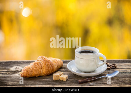 Coffee and croissant in sunrise Stock Photo