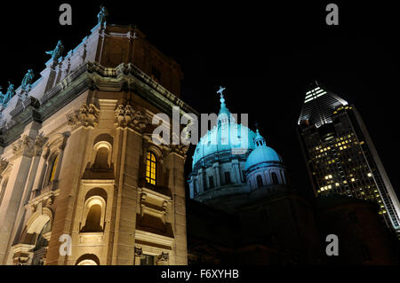 Highrise with Green dome and facade of Mary Queen of the World Basilica Montreal at night Stock Photo