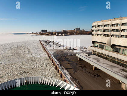 View from the Gulf of Finland covered with ice on St. Petersburg seaport and a lifeboat from a vessel in the foreground. Russia Stock Photo