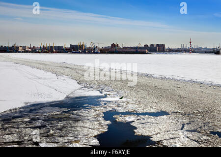 View from the Gulf of Finland covered with ice on St. Petersburg seaport and a lifeboat from a vessel in the foreground. Russia Stock Photo