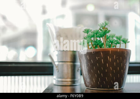 Pot of plastic plant on the table Stock Photo
