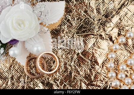 Wedding rings and flowers on a  fabric Stock Photo