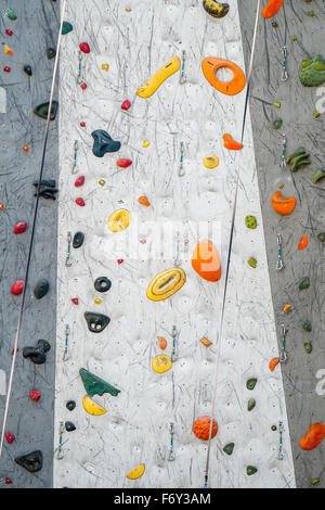 Detail of a climbing wall with variety of colorful handholds. Stock Photo