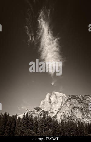 An interestingly shaped cloud hangs over Half Dome in Yosemite National Park Stock Photo
