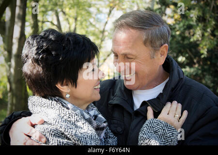 Senior married couple enjoying life and autumn days in park Stock Photo