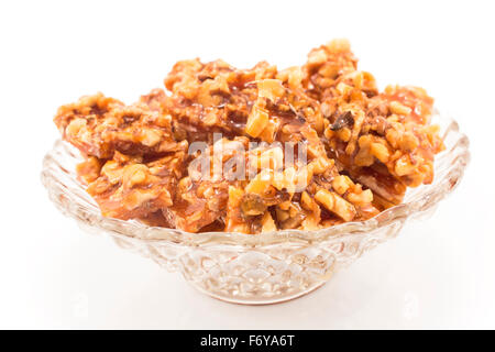 Homemade candies with walnuts in a glass bowl. Stock Photo