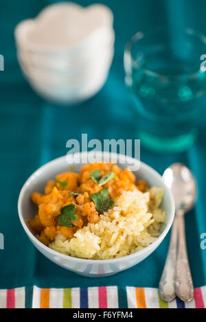 Closeup of traditional indian pumpkin curry with chick-peas and rice Stock Photo