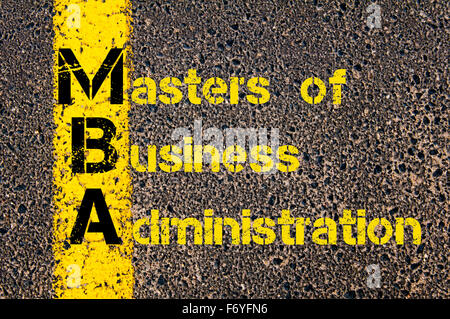 Concept image of Business Acronym MBA as Masters Of Business Administration written over road marking yellow paint line. Stock Photo