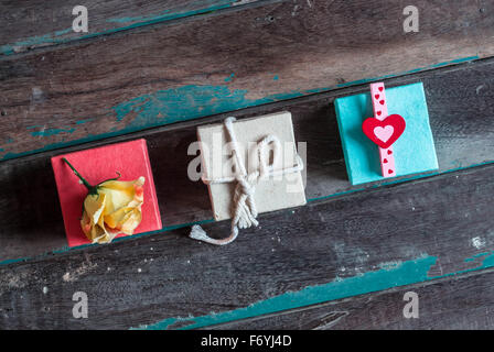 Multi-colored gift boxes on wooden background. Stock Photo