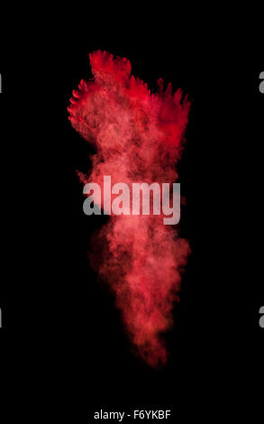 Freeze motion of red dust explosion on black background Stock Photo