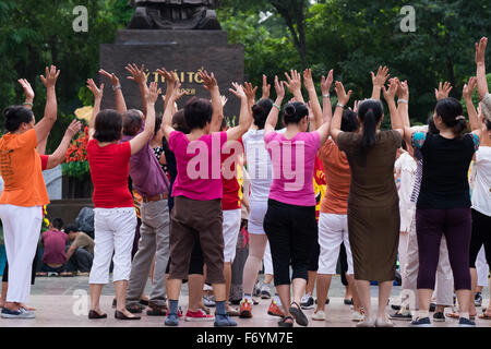 Members of the Hanoi Laughter Yoga Club gather early every morning at the Ly Thai To monument near the Hoan Kiem lake Stock Photo