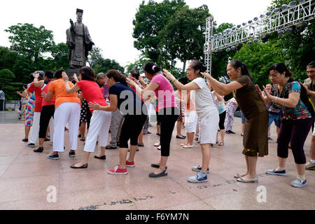 Members of the Hanoi Laughter Yoga Club gather early every morning at the Ly Thai To monument near the Hoan Kiem lake Stock Photo