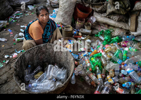 Dhaka, Bangladesh. 22nd Nov, 2015.  Ismat Ara lost her land due to riverbank erosion in 2004. After losing her only home, she migrated to Dhaka in search of fate and start working in this plastic recycling factory. Her son also working here after school. Credit:  Mohammad Ponir Hossain/ZUMA Wire/Alamy Live News Stock Photo