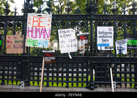 'Refugees welcome here' demonstration. Posters on Parliament fence include 'Be Human', 'Asylum is a Right' Stock Photo