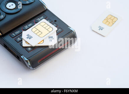 Group of mobile subscriber Identity Module, 3g memory sim cards  on a used black mobile Stock Photo