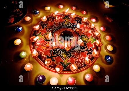 Diwali rangoli with colorful burning candles and diyas during hindu festival in India Stock Photo