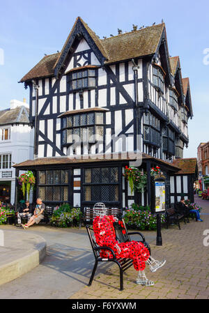Poppy Man sculpture sat in front of the Old House High Town Hereford UK