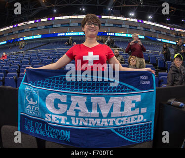 London, UK. 21st Nov, 2015. ATP Tennis Tour Finals. Day 8. Waiting for the finals to start. An early arriving Roger Federer fan poses with Roger Federer's embroidered towel. Stock Photo