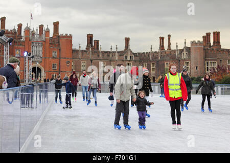 Hampton Court Palace, London, UK. 22nd November, 2015. Family fun at Hampton Court on the first weekend of open air ice skating in the grounds of the Royal Palace. Wrapped up warm to keep out the cold on a chilly day with a daytime high of only six degrees celsius beside the Thames in South West London. Credit:  Julia Gavin UK/Alamy Live News Stock Photo