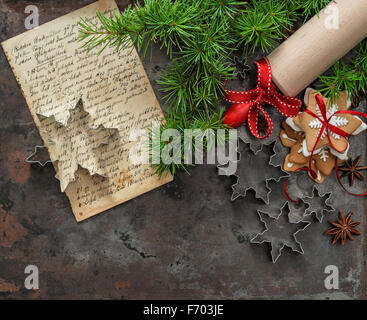 Christmas cookies. Baking ingredients, recipe book, rolling pin and cookie cutters Stock Photo