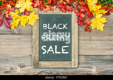 Background with colorful leaves and blackboard. Sale concept. Sample text Black Friday Sale Stock Photo