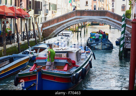 Delivery barges on a Castello canal Venice Veneto Italy Europe Stock Photo