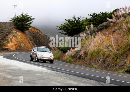 Road in the fog leading to Half Moon Bay, California Stock Photo