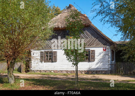 The Museum of the Mazovian Countryside in Sierpc, Poland. Old wooden peasant farmhouse with thatched roof. Stock Photo