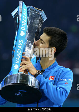 London, Britain. 22nd Nov, 2015. Novak Djokovic of Serbia celebrates with the trophy after winning the men's single's final against Roger Federer of Switzerland at the ATP World Tour Finals at the O2 Arena in London, Britain, Nov. 22, 2015. Djokovic won 2-0. © Han Yan/Xinhua/Alamy Live News Stock Photo