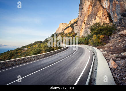 Asphalt road in autumn forest Stock Photo - Alamy