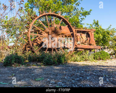 An antique abandoned deteriorated tractor rusting away in a field in San Luis Obispo County, California. Stock Photo