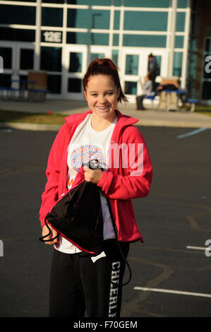 Junior high school girl smiling outside school. Stock Photo