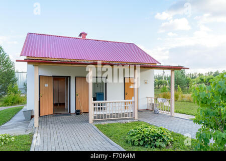 Public toilet in a beautiful park in the evening. Front view. Stock Photo