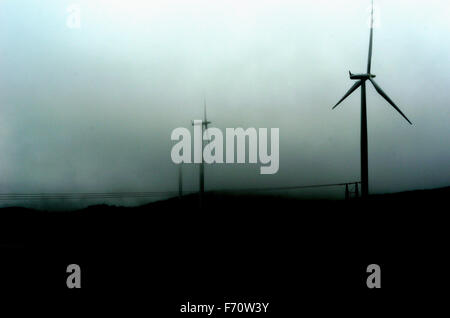 windmill on mountain top on dark and rain heavy summer day Stock Photo