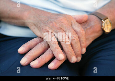 Elderly mans hands on lap, Stock Photo