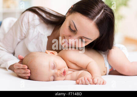 happy young mom near sleeping baby Stock Photo