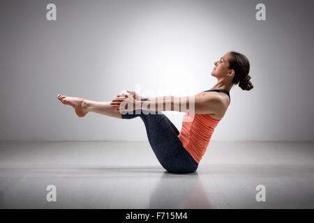 Sporty fit woman practices Ashtanga Vinyasa yoga Stock Photo