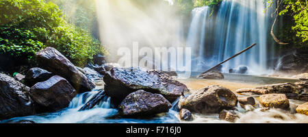 Tropical waterfall in jungle with sun rays Stock Photo