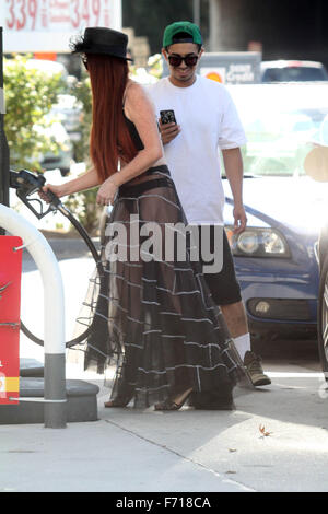 Phoebe Price, wearing a see-thru outfit filling up her SUV at a gas ...