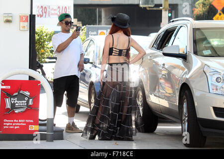 Phoebe Price, wearing a see-thru outfit filling up her SUV at a gas ...