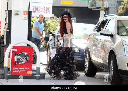 Phoebe Price, wearing a see-thru outfit filling up her SUV at a gas ...