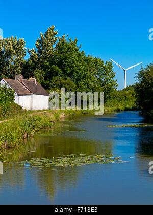 Wind turbine and  towpath on Nottingham Canal at Awsworth Nottinghamshire England UK built 1796 and now used for fishing Stock Photo