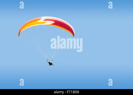 Tandem paraglider free gliding at high altitude in deep blue sky Stock Photo